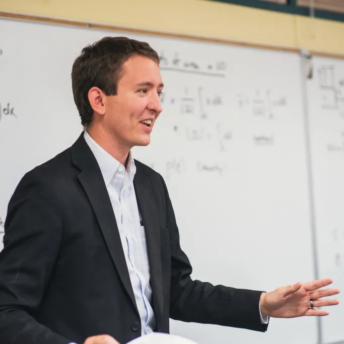 faculty member at whiteboard