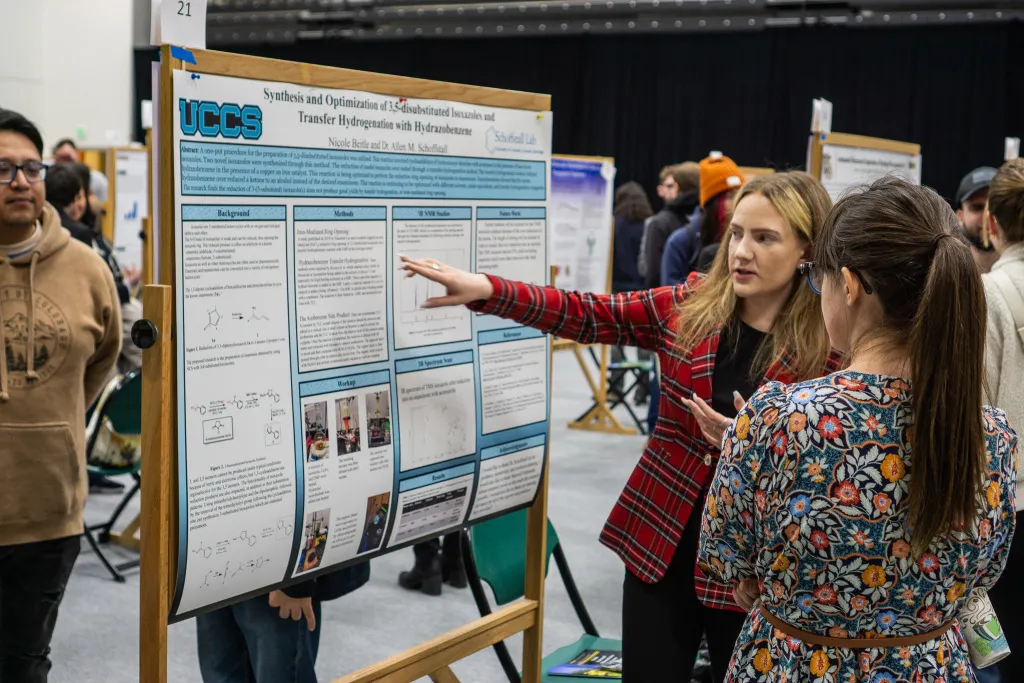 student presenting their research poster at mountain lion research day